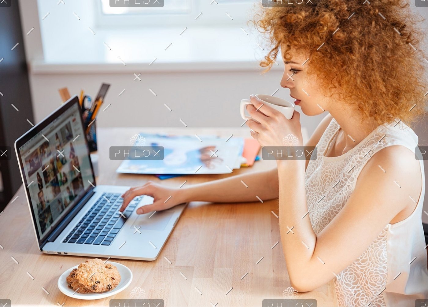 demo-attachment-410-woman-photographer-drinking-coffee-and-working-PJNBP6U